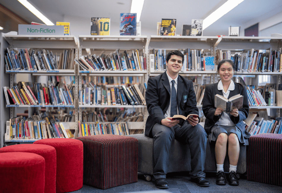A photo showing two students reading in their school library 